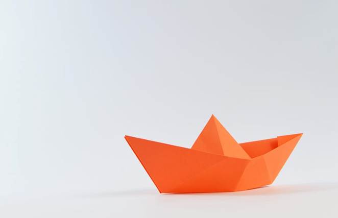 Orange Paper Boat on White Surface